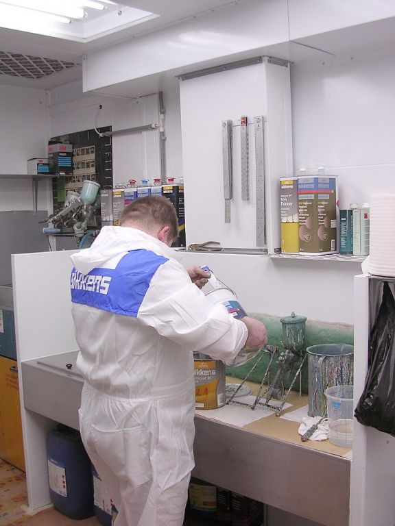 Painter is mixing the coatings on a ventilated table